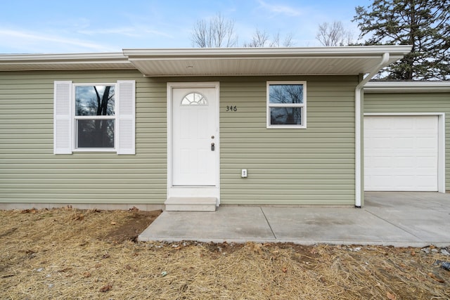 view of exterior entry with a garage