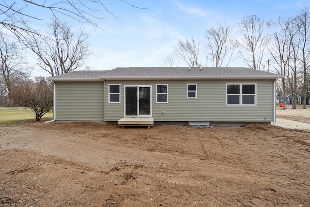 back of property with roof with shingles