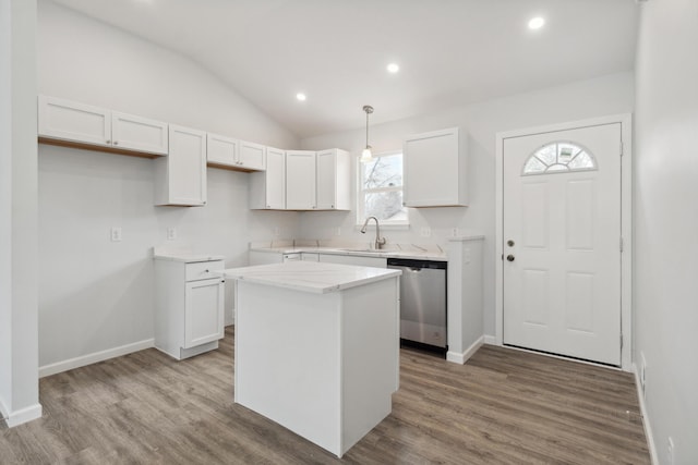 kitchen featuring lofted ceiling, white cabinetry, dishwasher, and wood finished floors