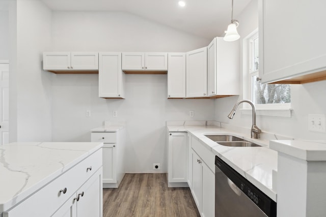 kitchen featuring lofted ceiling, stainless steel dishwasher, a sink, and light stone counters