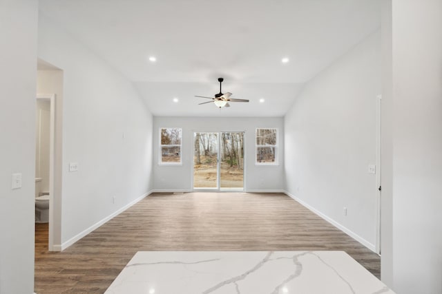 unfurnished living room featuring baseboards, wood finished floors, a ceiling fan, and recessed lighting