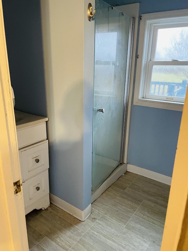 bathroom featuring vanity and a shower with shower door