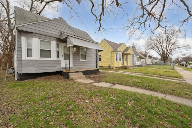 bungalow-style home with a front yard