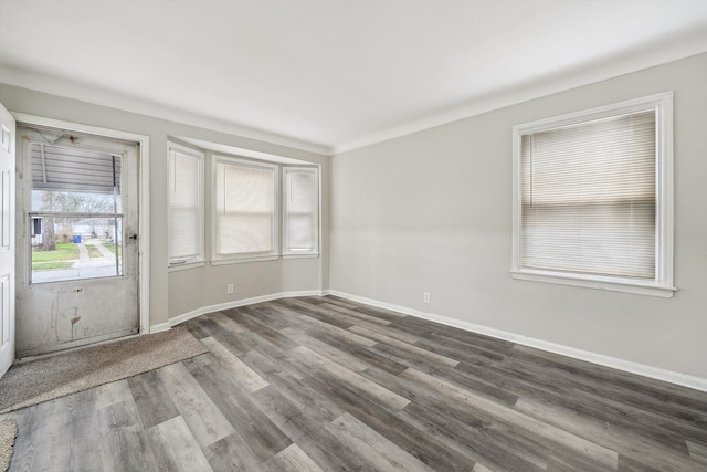 unfurnished room featuring hardwood / wood-style floors and crown molding