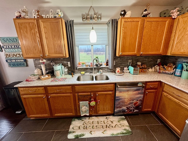 kitchen featuring decorative backsplash, decorative light fixtures, dark tile patterned floors, and sink