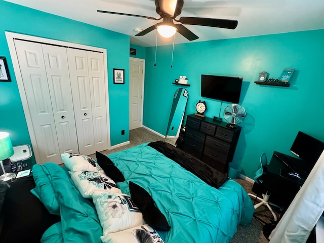 carpeted bedroom featuring ceiling fan and a closet