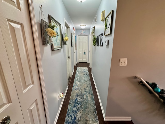 corridor with dark wood-type flooring