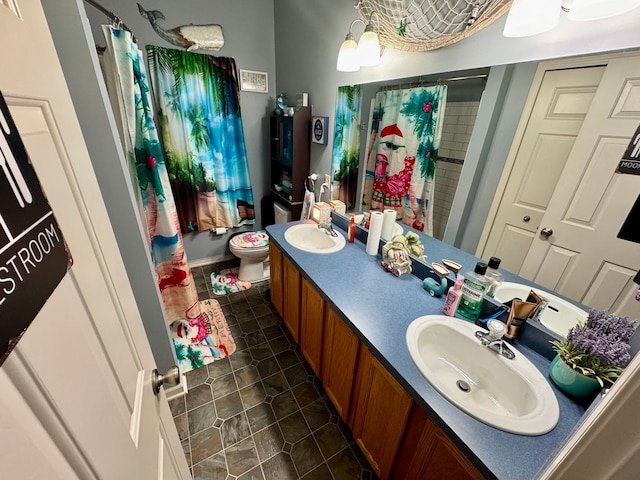 bathroom with tile patterned floors, vanity, and toilet