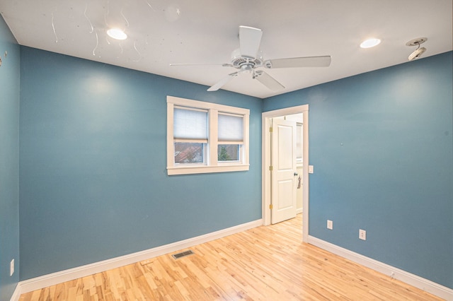 empty room with light hardwood / wood-style floors and ceiling fan