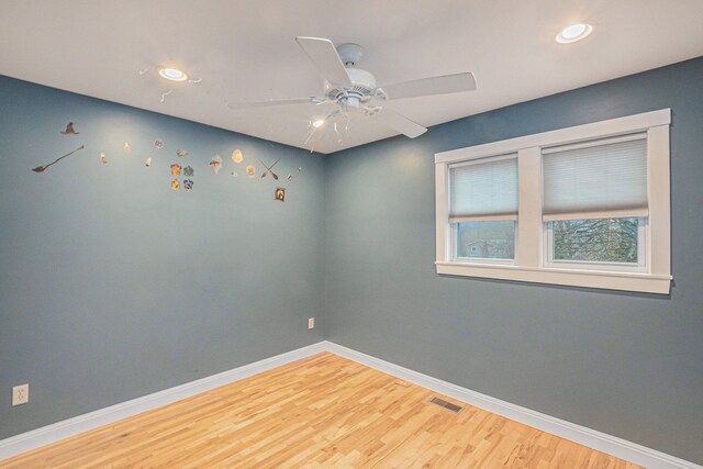 spare room featuring hardwood / wood-style flooring and ceiling fan