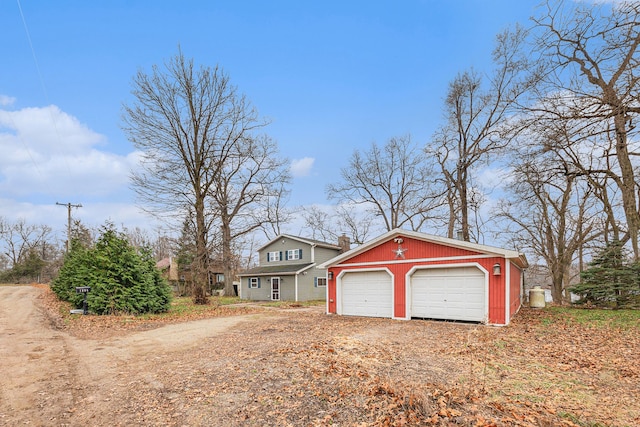 exterior space with a garage and an outdoor structure