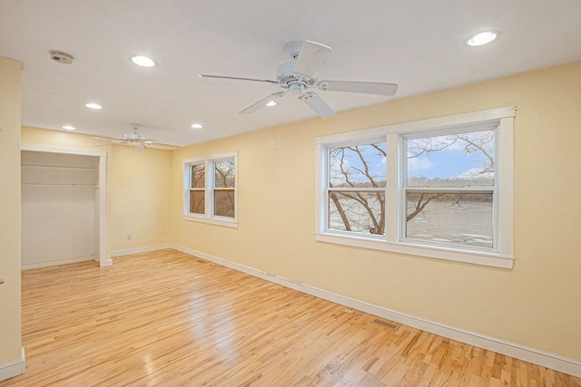 unfurnished room featuring light hardwood / wood-style floors and ceiling fan