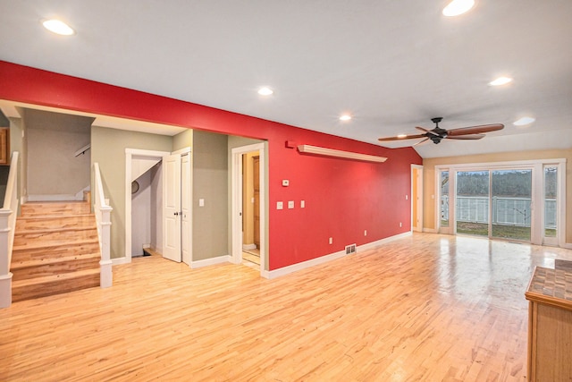 unfurnished living room featuring ceiling fan, lofted ceiling, and light wood-type flooring