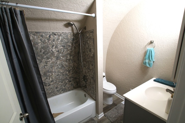 full bathroom with hardwood / wood-style floors, vanity, shower / bath combo, and toilet