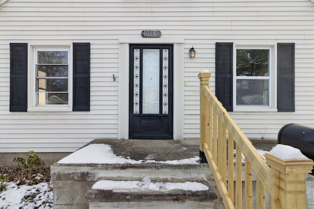 view of snow covered property entrance