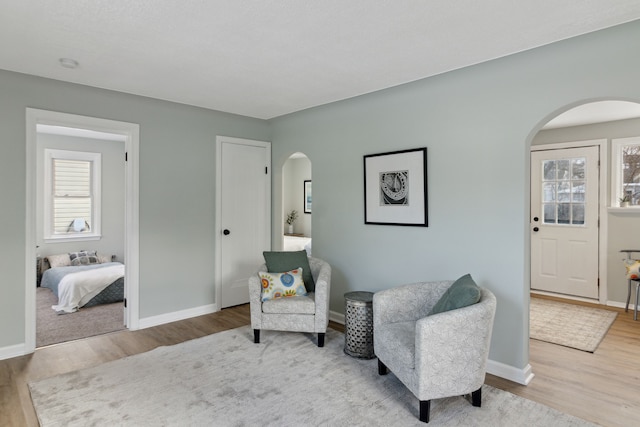 sitting room with wood-type flooring