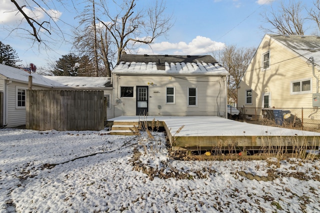 snow covered property featuring a deck