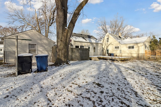 snow covered property with a wooden deck