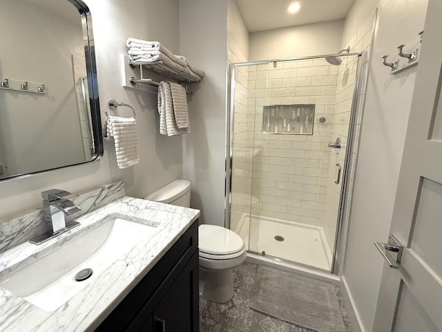 bathroom featuring vanity, toilet, and walk in shower