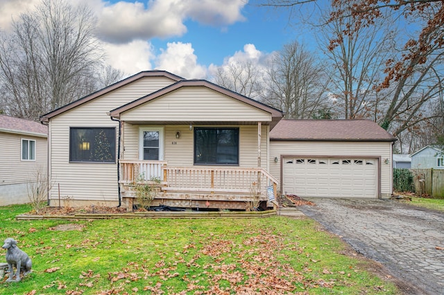 view of front facade with covered porch, a garage, and a front yard