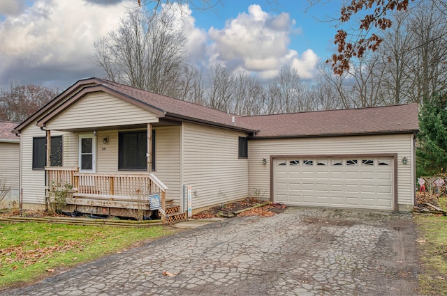 ranch-style home with a porch and a garage