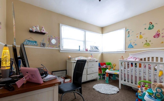 bedroom featuring dark colored carpet and a nursery area