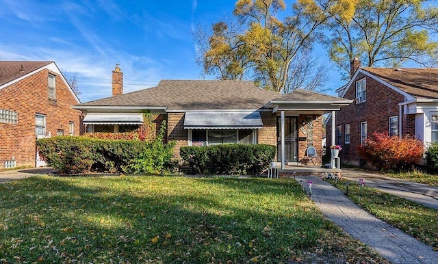 bungalow-style house with a front lawn