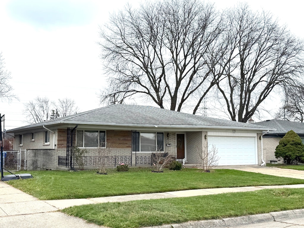 ranch-style house with a front lawn and a garage