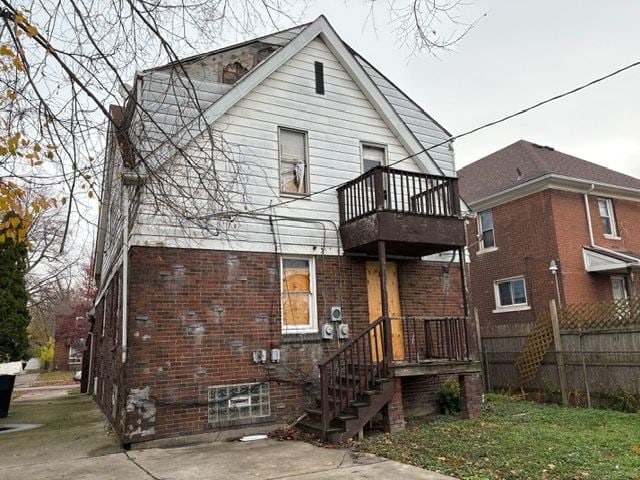 rear view of property featuring a balcony