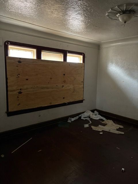 spare room with plenty of natural light and a textured ceiling