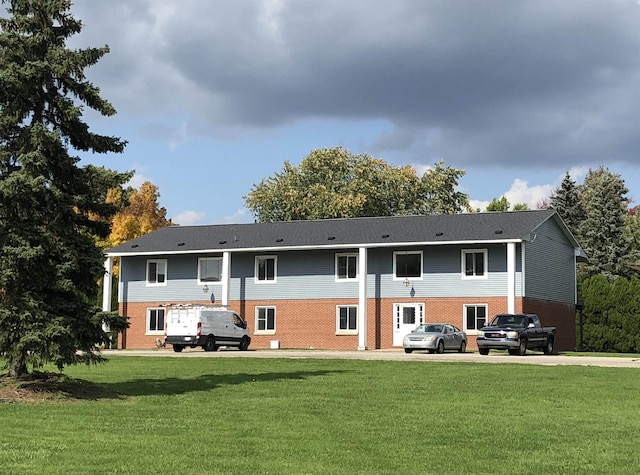 rear view of property with a lawn