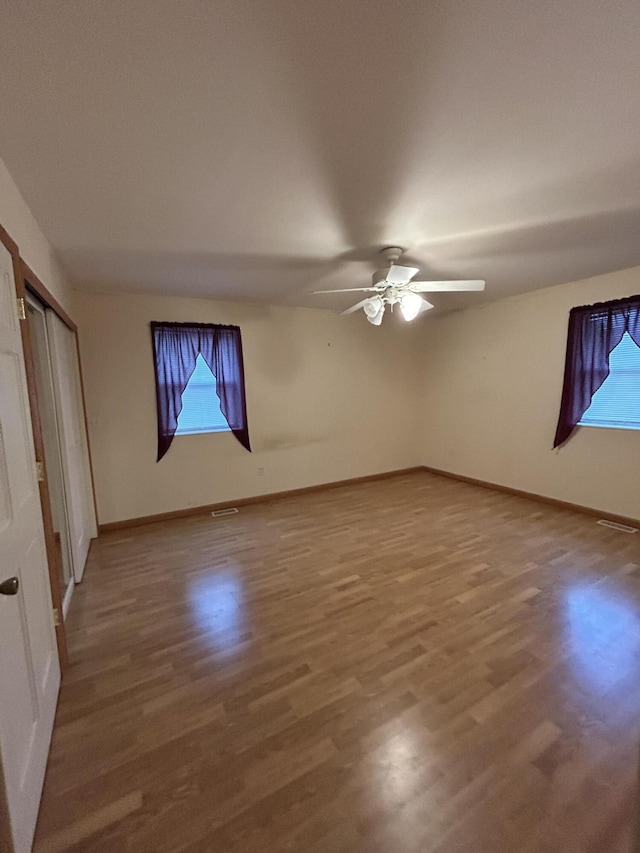 832 E Park Dr, Niles, MI 49120 - unfurnished bedroom featuring multiple windows, wood finished floors, and ceiling fan