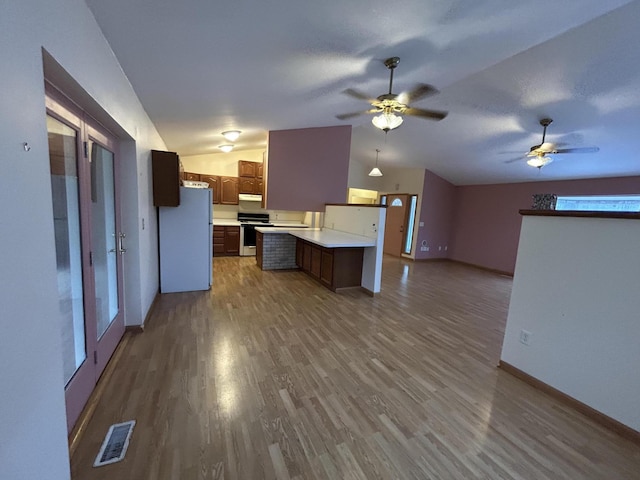 832 E Park Dr, Niles, MI 49120 - kitchen featuring vaulted ceiling, freestanding refrigerator, gas stove, open floor plan, and light countertops