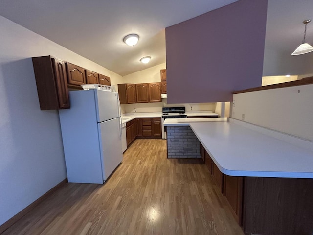 832 E Park Dr, Niles, MI 49120 - kitchen with white appliances, light wood-type flooring, a peninsula, light countertops, and lofted ceiling