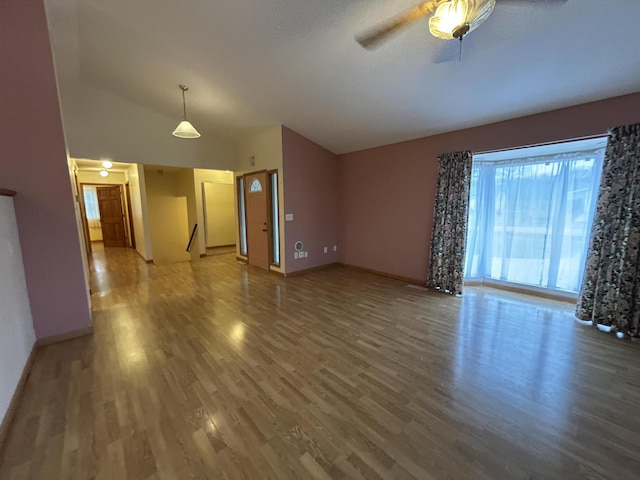 832 E Park Dr, Niles, MI 49120 - unfurnished living room with wood finished floors, vaulted ceiling, and a ceiling fan