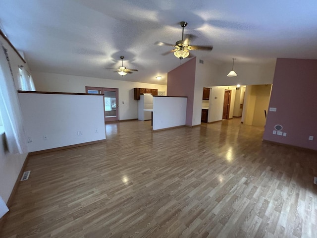 832 E Park Dr, Niles, MI 49120 - unfurnished living room with a ceiling fan, wood finished floors, and vaulted ceiling