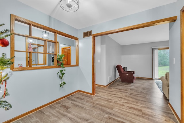 hallway with light hardwood / wood-style flooring