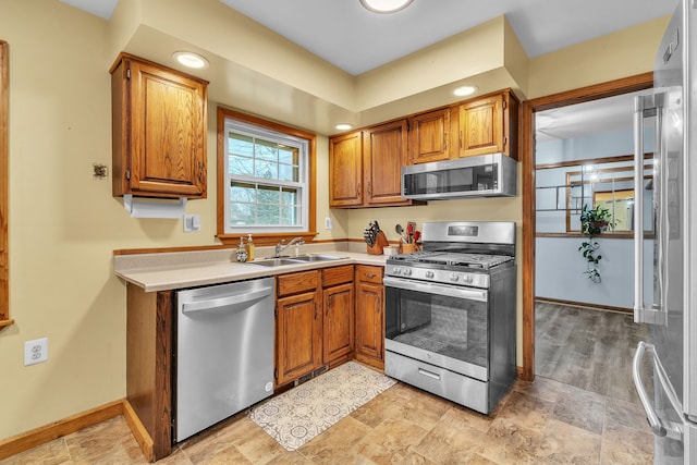 kitchen with light wood-type flooring, stainless steel appliances, and sink