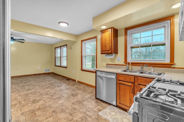 kitchen featuring stainless steel dishwasher, ceiling fan, white gas range, and sink