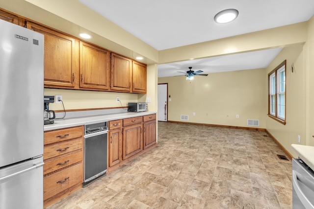 kitchen with ceiling fan and appliances with stainless steel finishes