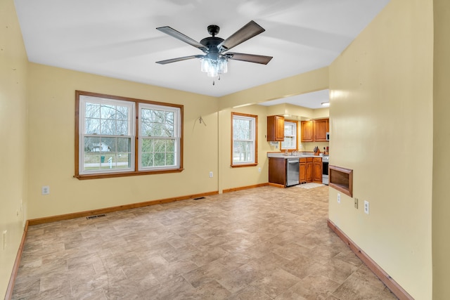 unfurnished living room with plenty of natural light and ceiling fan