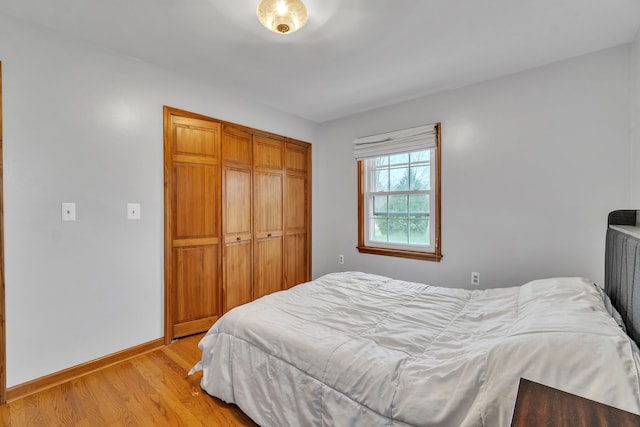 bedroom featuring a closet and light wood-type flooring