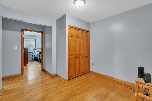 hall with light hardwood / wood-style floors