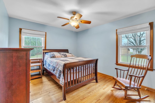 bedroom featuring light hardwood / wood-style floors and ceiling fan