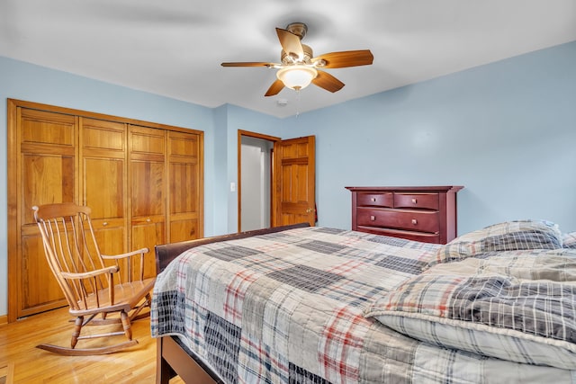 bedroom with ceiling fan, a closet, and light hardwood / wood-style floors