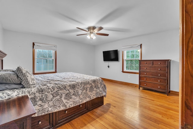 bedroom with ceiling fan and light hardwood / wood-style flooring