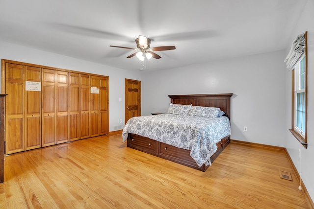 bedroom featuring light wood-type flooring, a closet, and ceiling fan