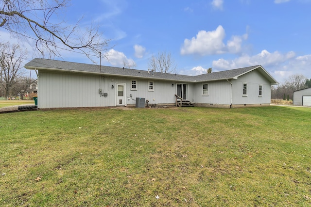 rear view of house with a lawn and cooling unit