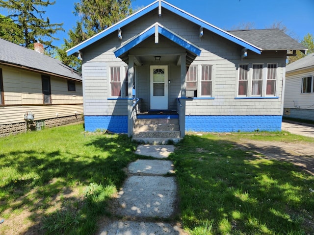 bungalow-style home featuring a front yard