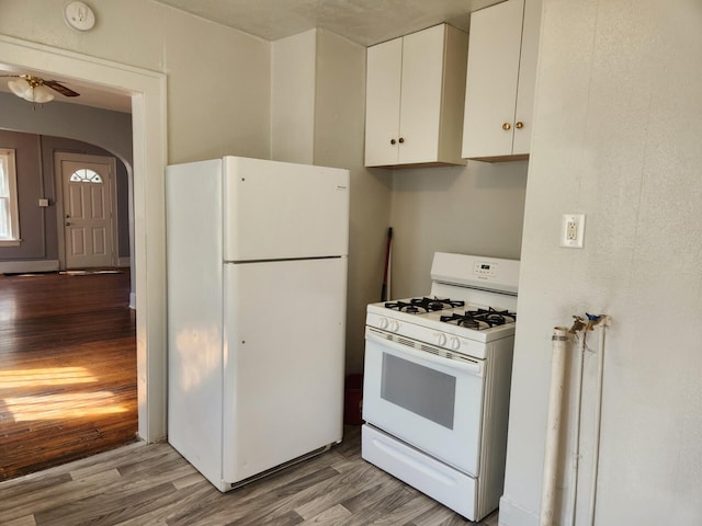 kitchen featuring ceiling fan, white cabinets, light hardwood / wood-style floors, and white appliances